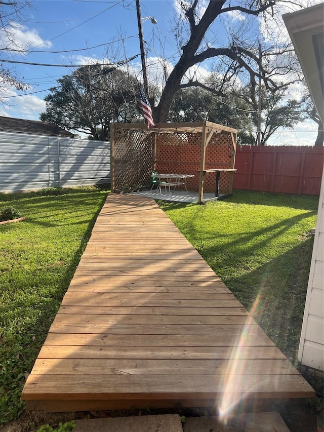 wooden deck with a patio area and a lawn