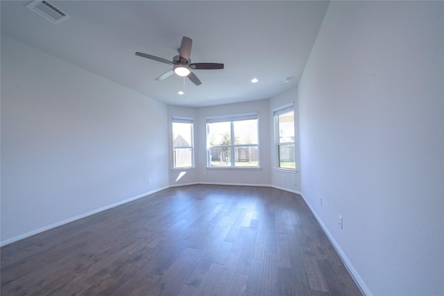 empty room with recessed lighting, dark wood-style flooring, visible vents, and baseboards