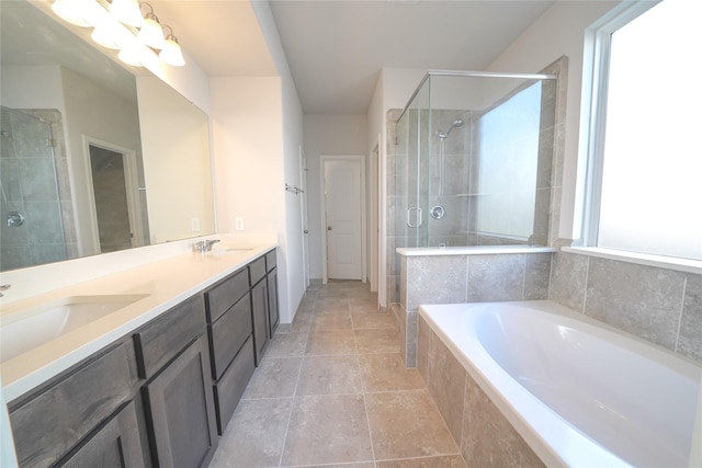 full bath with a sink, double vanity, a shower stall, and a bath