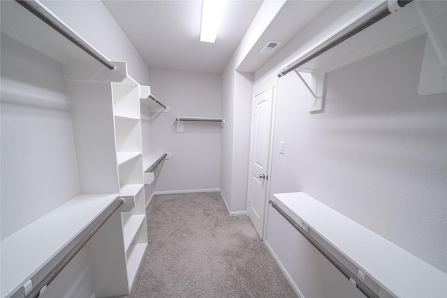 spacious closet with light carpet and visible vents