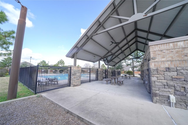 exterior space featuring fence and a community pool