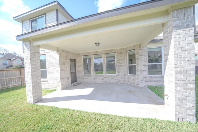 view of patio / terrace with an attached carport and fence