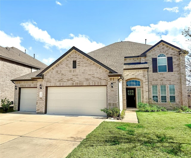 view of front of house with a garage and a front lawn