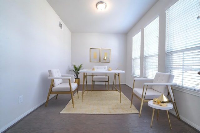 sitting room featuring visible vents, baseboards, and wood finished floors