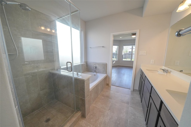 bathroom featuring a garden tub, a sink, and a stall shower