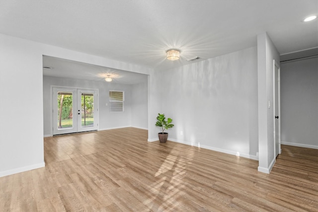 empty room featuring light hardwood / wood-style floors and french doors