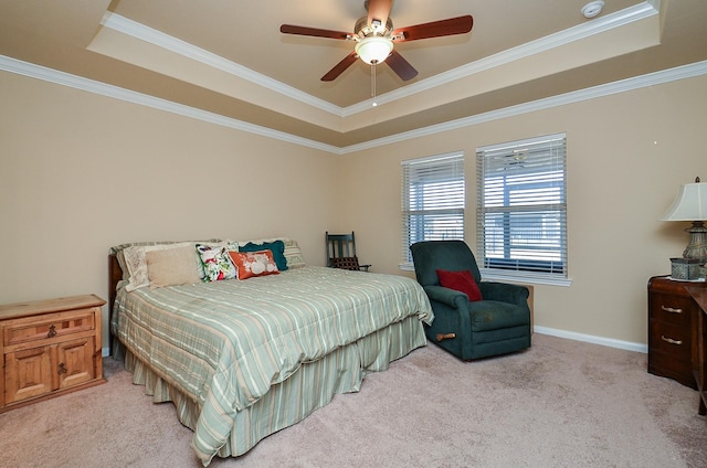 bedroom featuring crown molding, a tray ceiling, and light colored carpet