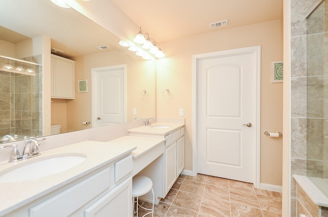 bathroom with vanity, an enclosed shower, and toilet