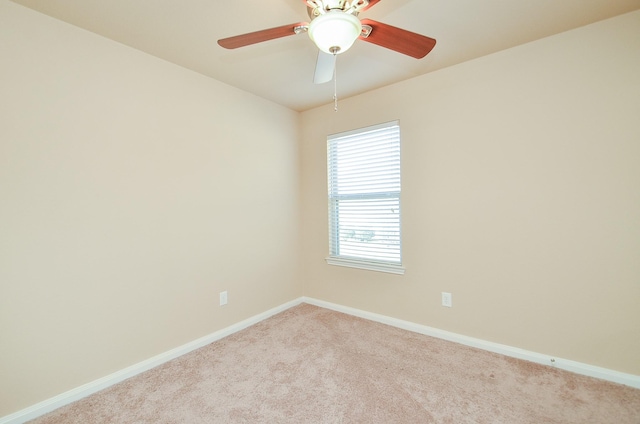 empty room featuring ceiling fan and light colored carpet