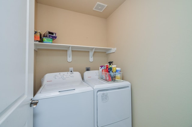 washroom featuring washer and clothes dryer