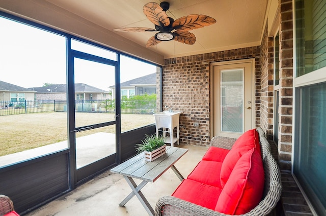 sunroom / solarium with sink and ceiling fan