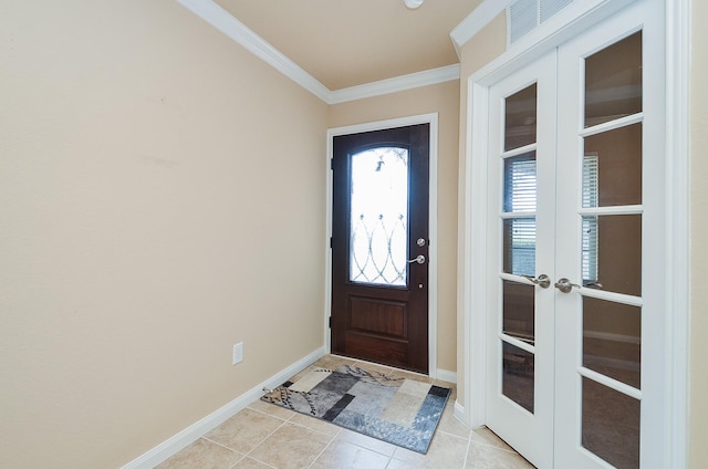 tiled foyer featuring crown molding and french doors