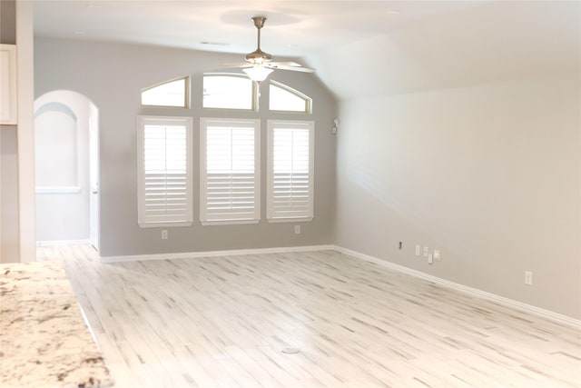 interior space with lofted ceiling, ceiling fan, and light wood-type flooring