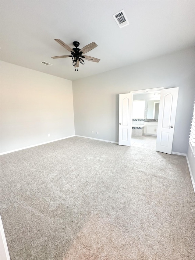 carpeted spare room featuring ceiling fan