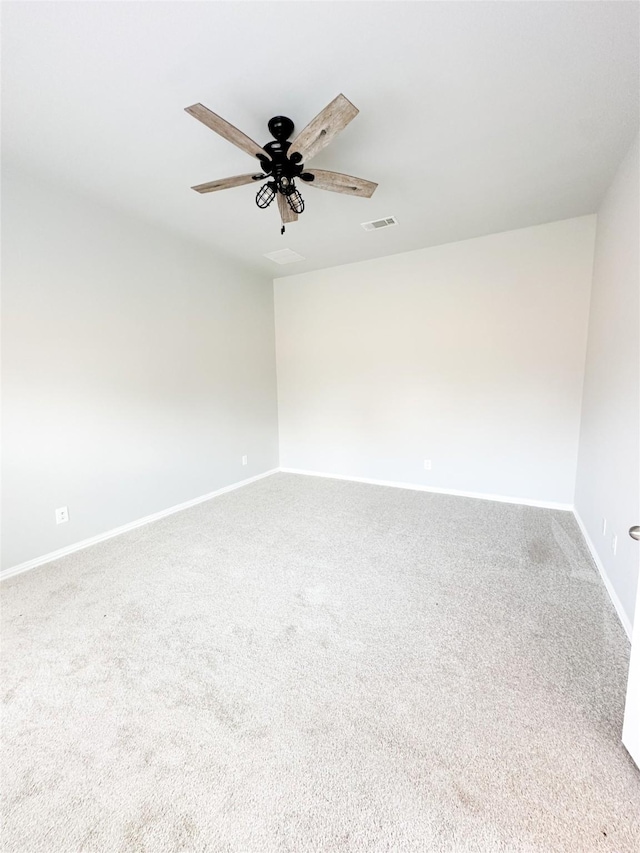 spare room with ceiling fan and carpet