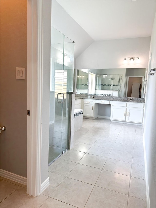 bathroom featuring lofted ceiling, vanity, an enclosed shower, and tile patterned flooring