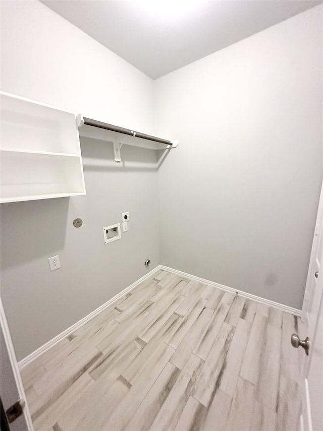 clothes washing area featuring hookup for a gas dryer, electric dryer hookup, hookup for a washing machine, and light wood-type flooring