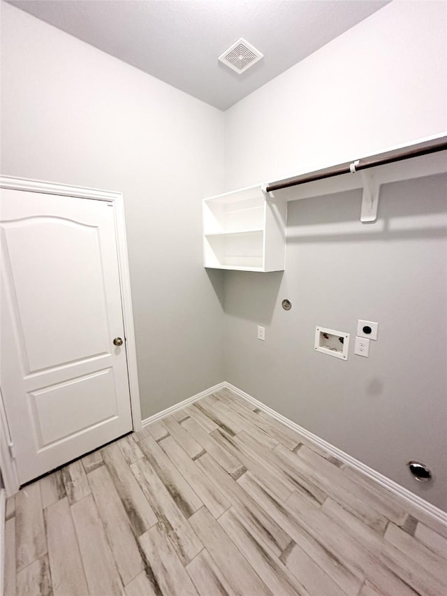 laundry room featuring hookup for a washing machine, electric dryer hookup, light wood-type flooring, and hookup for a gas dryer