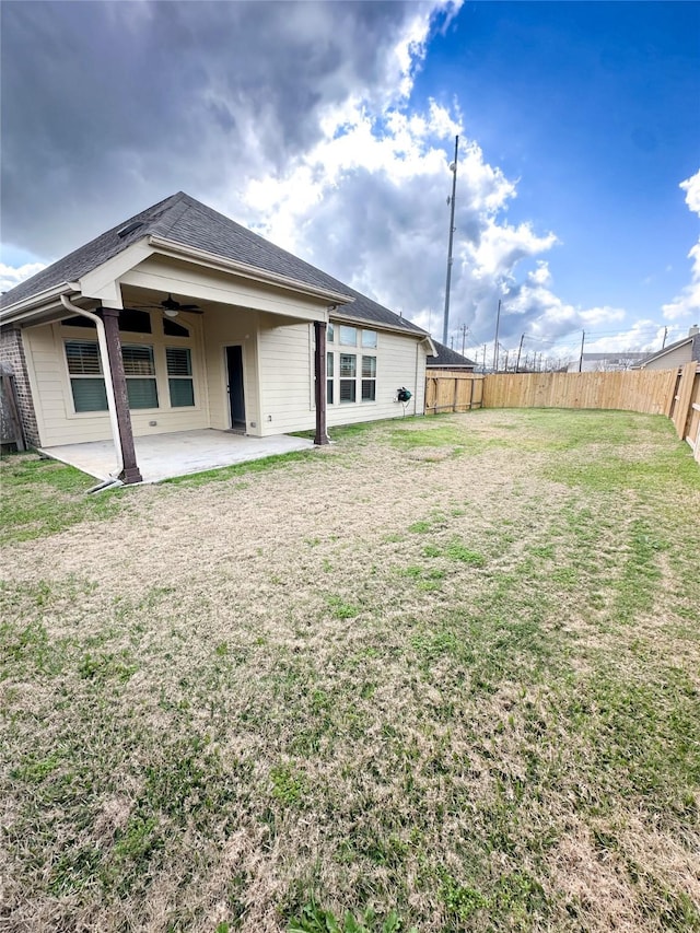 rear view of house featuring a yard, a patio area, and ceiling fan