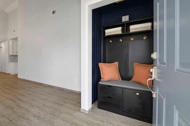 mudroom featuring light wood finished floors and visible vents