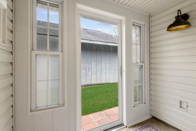 doorway featuring wooden walls