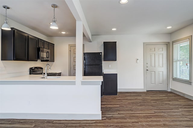 kitchen featuring decorative light fixtures, black appliances, sink, hardwood / wood-style flooring, and kitchen peninsula