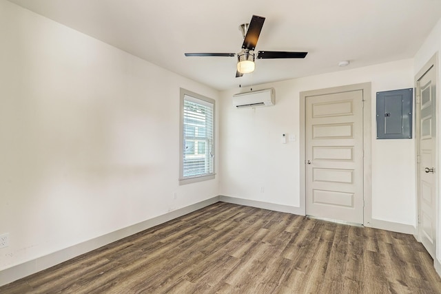 unfurnished room featuring ceiling fan, hardwood / wood-style floors, electric panel, and a wall unit AC