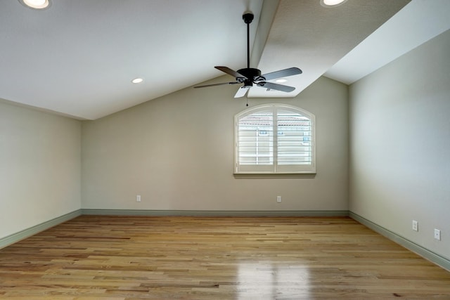 unfurnished room featuring lofted ceiling, ceiling fan, and light hardwood / wood-style flooring