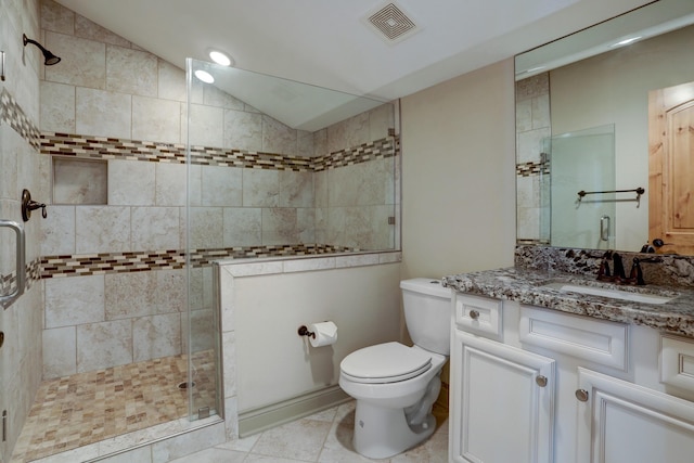 bathroom with an enclosed shower, vanity, vaulted ceiling, tile patterned floors, and toilet