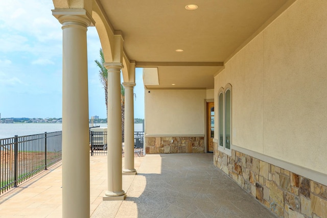 view of patio with a water view