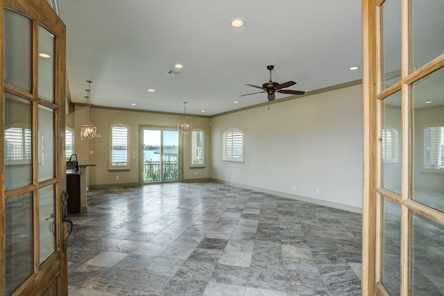 empty room with ornamental molding and ceiling fan with notable chandelier