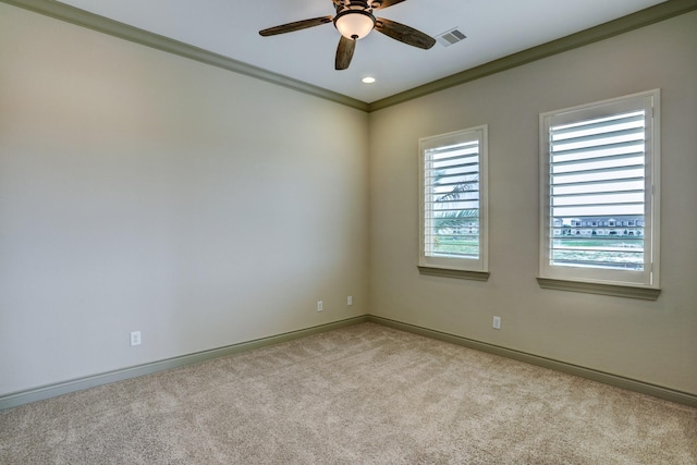 empty room with light carpet, crown molding, and ceiling fan