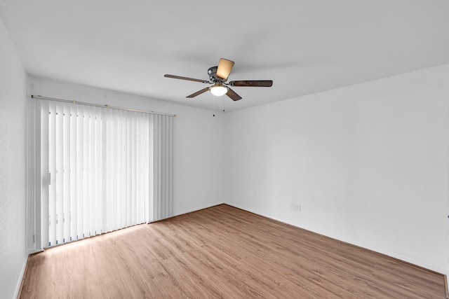 empty room with a ceiling fan and wood finished floors