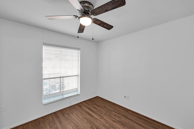 unfurnished room featuring wood finished floors, a ceiling fan, and baseboards