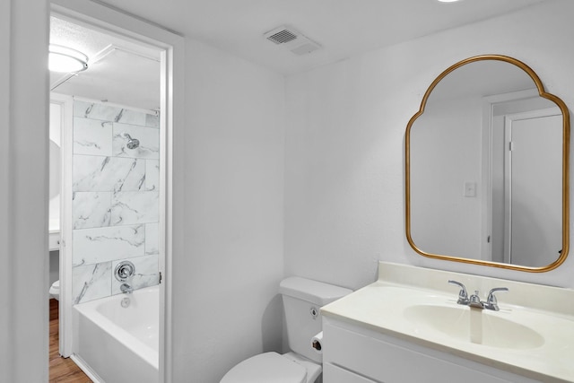 bathroom featuring toilet, visible vents, shower / washtub combination, and vanity