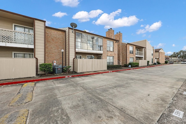 view of building exterior with uncovered parking