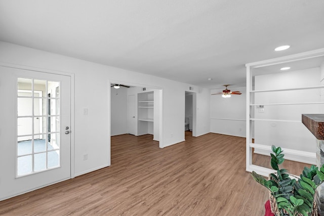 unfurnished living room featuring recessed lighting, a ceiling fan, baseboards, baseboard heating, and light wood-type flooring