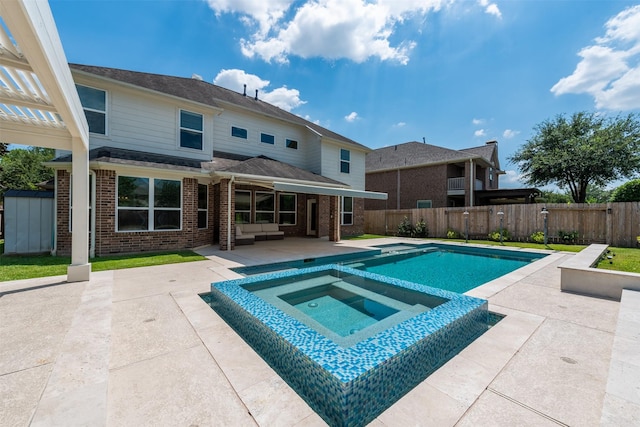 view of pool with an outdoor living space, an in ground hot tub, a pergola, and a patio