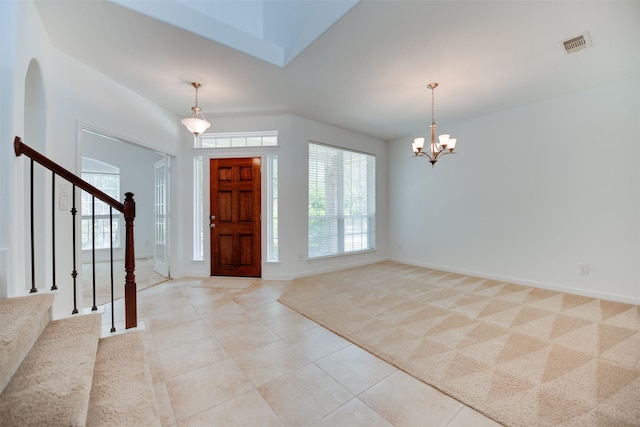 entrance foyer featuring light carpet and a notable chandelier