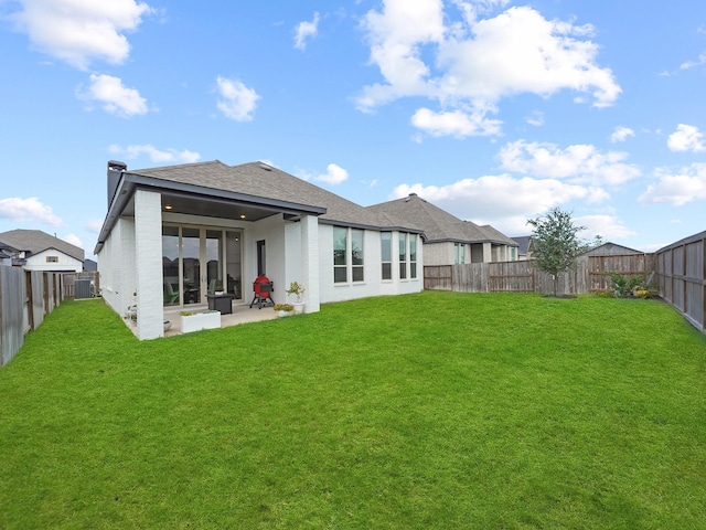 rear view of property featuring a patio, central AC, and a lawn