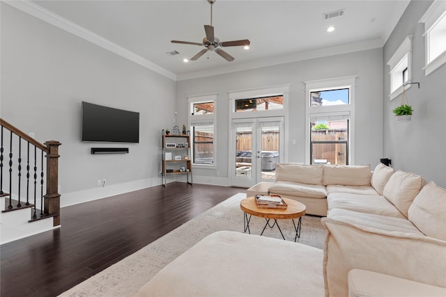 living room with dark wood-type flooring, ornamental molding, french doors, and ceiling fan