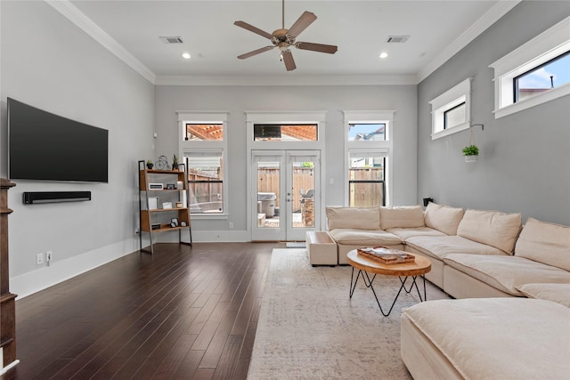 living room featuring ornamental molding, dark hardwood / wood-style floors, a healthy amount of sunlight, and french doors