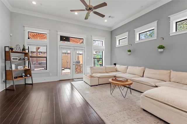 living room featuring crown molding, hardwood / wood-style flooring, plenty of natural light, and french doors