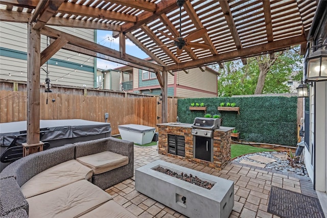 view of patio / terrace featuring exterior kitchen, a pergola, a hot tub, and a fire pit