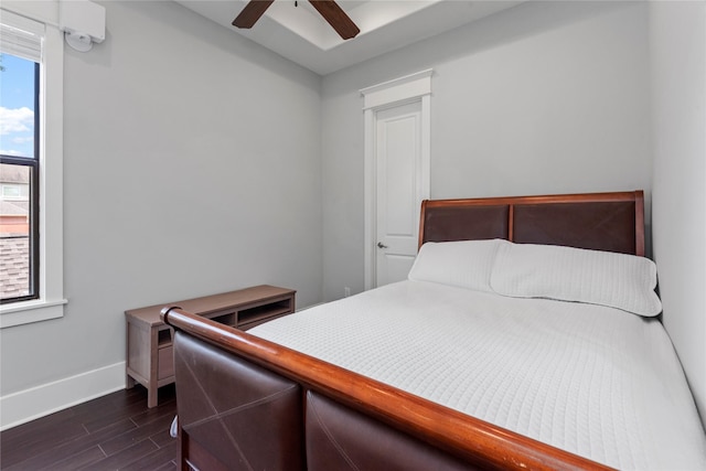 bedroom with multiple windows, dark hardwood / wood-style floors, and ceiling fan