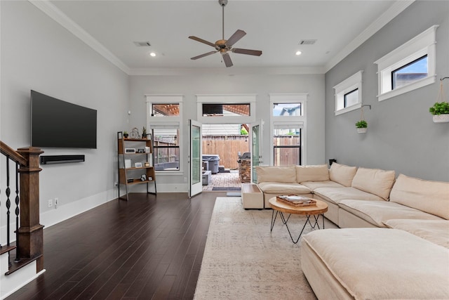 living room with ornamental molding, ceiling fan, and dark hardwood / wood-style flooring