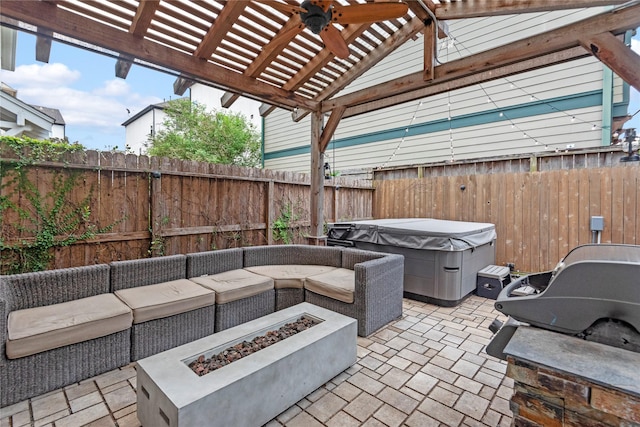 view of patio / terrace featuring ceiling fan, a hot tub, a pergola, and an outdoor living space with a fire pit