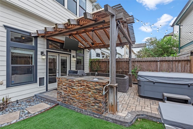 view of patio / terrace featuring a pergola, a hot tub, area for grilling, grilling area, and a bar