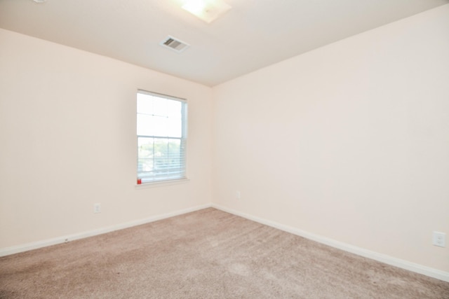 unfurnished room featuring light carpet, baseboards, and visible vents