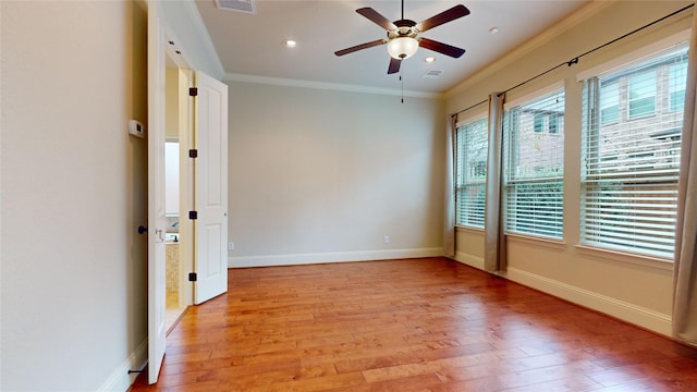 unfurnished room featuring light hardwood / wood-style flooring, ornamental molding, and ceiling fan